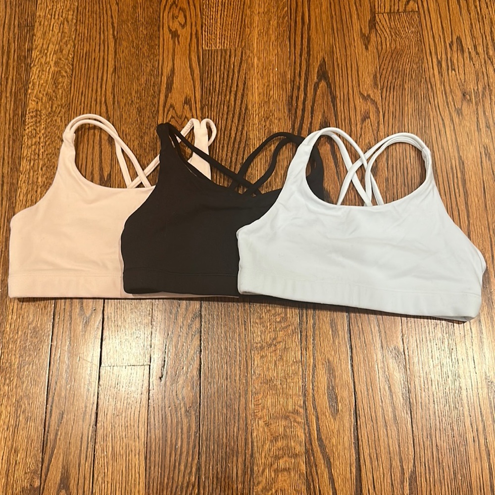 Athleta girl sports bra size 8-10, colors: light pink, black, pastel blue.